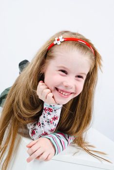 studio shot of laughing pretty little girl with wide smile