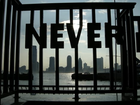 word NEVER in steel railing, new jersey in background