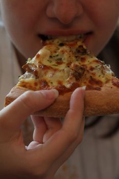 Close up of the person eating pizza.