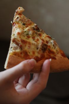 Close up of the person eating pizza.