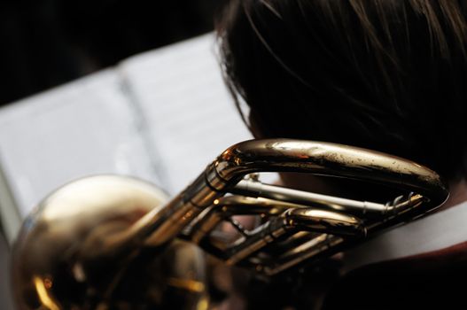 Shot of man playing trombone with his band on stage