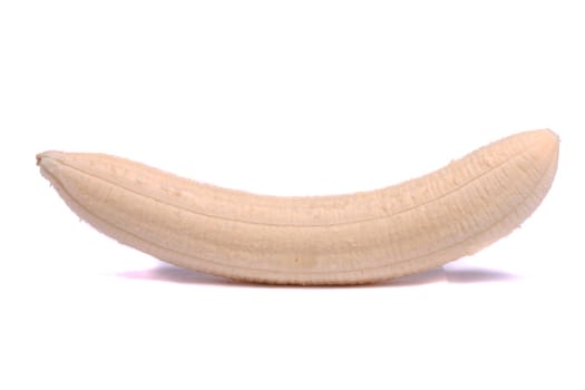 Close up view of a peeled banana with no skin isolated on a white background.