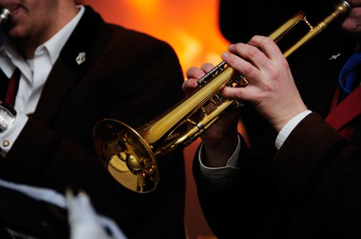 Shot of man playing trumpet with his band on stage