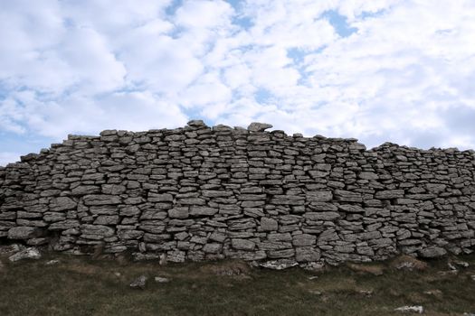 rocky boundary walls in scenic west ireland with a cloudy background