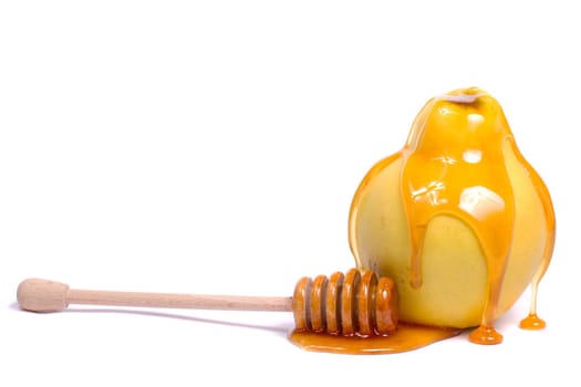 Close up view of a quince fruit with a honey dipper isolated on a white background.