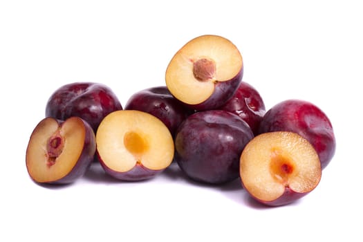 Close up view of some violet plums isolated on a white background.