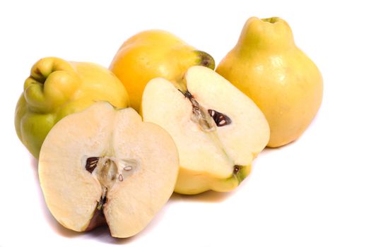 Close up view of some quince fruits isolated on a white background.