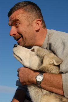portrait of an happy man and his siberian husky
