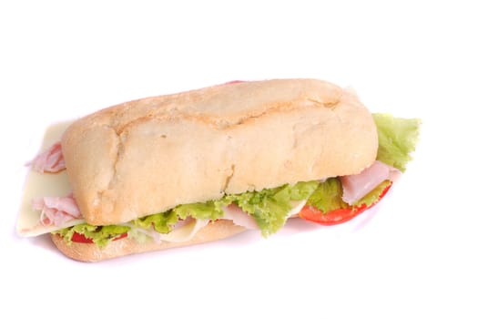 Close view of a fresh tasty ciabatta sandwich with tomato, lettuce, cheese and ham isolated on a white background.