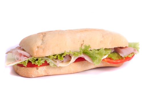 Close view of a fresh tasty ciabatta sandwich with tomato, lettuce, cheese and ham isolated on a white background.