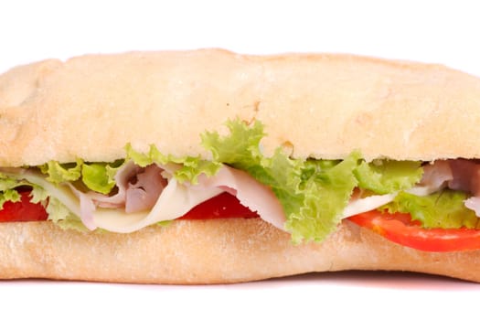 Close view of a fresh tasty ciabatta sandwich with tomato, lettuce, cheese and ham isolated on a white background.