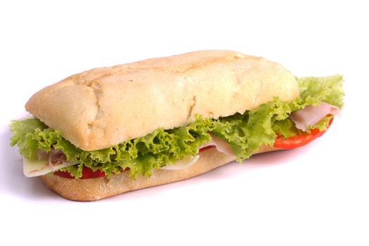 Close view of a fresh tasty ciabatta sandwich with tomato, lettuce, cheese and ham isolated on a white background.
