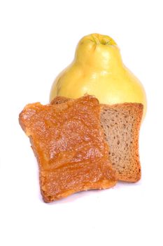 Close view of some quince fruit with a piece of toasted bread with jam isolated on a white background.