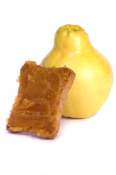 Close view of some quince fruit with a piece of toasted bread with jam isolated on a white background.