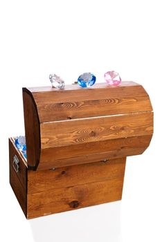 A treasure chest filled with rubies, saphires, and diamonds, isolated against a white background