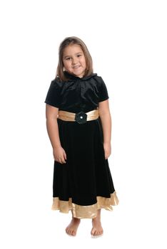 A full length view of a  cute five year old girl wearing a black dress, isolated against a white background
