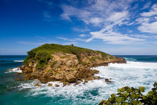 Rocky island in surf off the north east coast of Puerto Rico