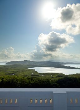 View across a lagoon towards El Yunque across with the distant rain falling on the rain forest