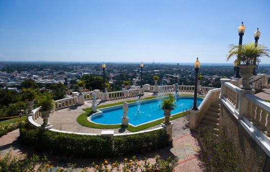 City of Ponce below a smart swimming pool overlooking the city