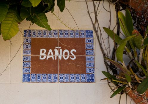 Tiles in wall indicating Banos or bathroom in Spanish