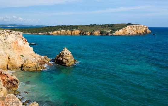 Rocky island in surf off the south west coast of Puerto Rico by Los Morillos Lighthouse