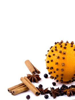 Aromatic Christmas orange with spices on white background