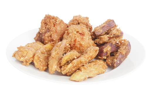 Deep fried sliced banana (in Thai call "Kluay khek"), fried sweet potato and jackfruit genus Artocarpus (Chempedek) seed on plate isolated on white background