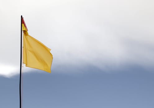 A red and yellow swimming safety flag on an Lithuanian beach