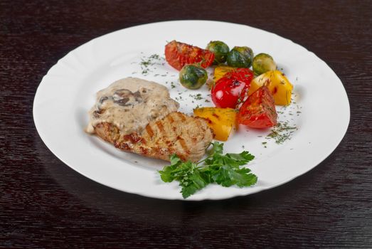 pork steak with mushroom sauce and grilled vegetables