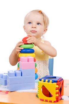 Baby girl playing pyramid over white