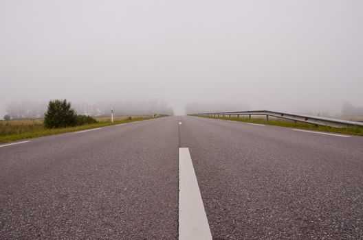 countryside road and summer morning mist