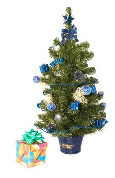 Gift box with a bow and artificial fur-tree on a white background.