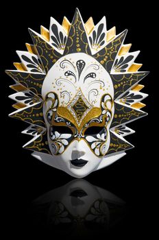 Gold traditional venetian carnival mask isolated on black. Venice, Italy.