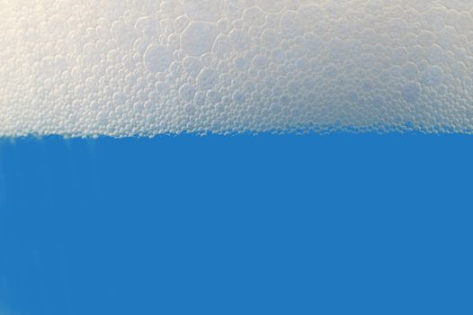 colored drink with foam isolated on white background