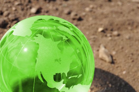 climate change concept with earth planet on dry soil and copyspace