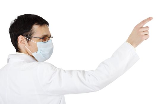 The doctor in a medical mask points a finger on white