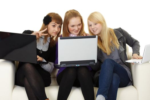 Girls communicate on the Internet with foreigners on sofa
