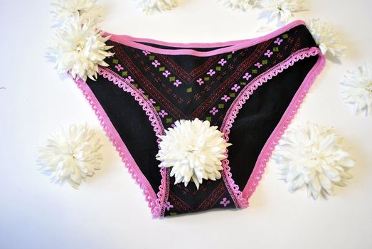 Female shorts and white flower - a symbol of female health