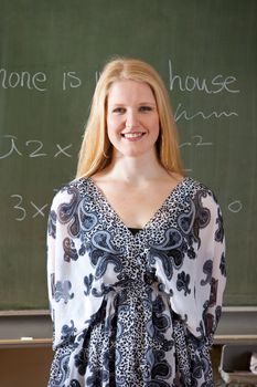 Pretty blond girl standing in front of the class
