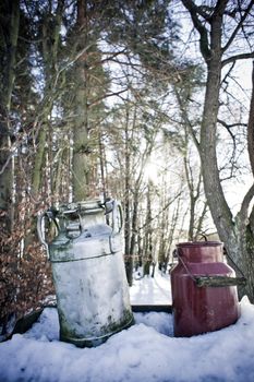 Nostalgic Milk Cans in Winter Landscape waiting for refill