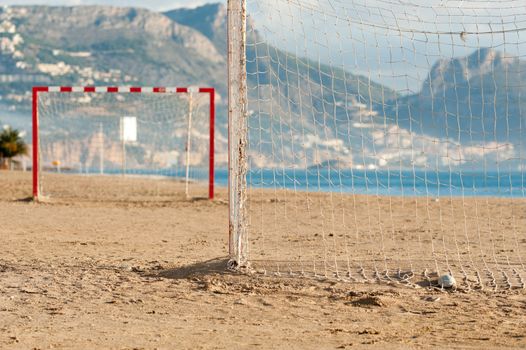 Small five-to-five soccer goals on a sandy beach