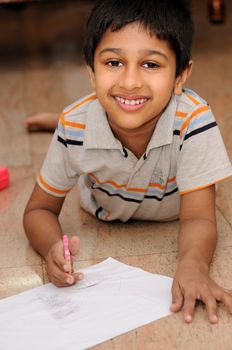 An Handsome Indian boy doing his artwork
