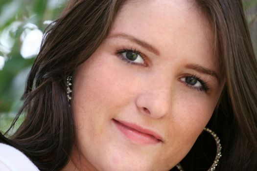 Close up of young girl's face with earrings