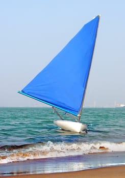 The sailboat docked at the shore