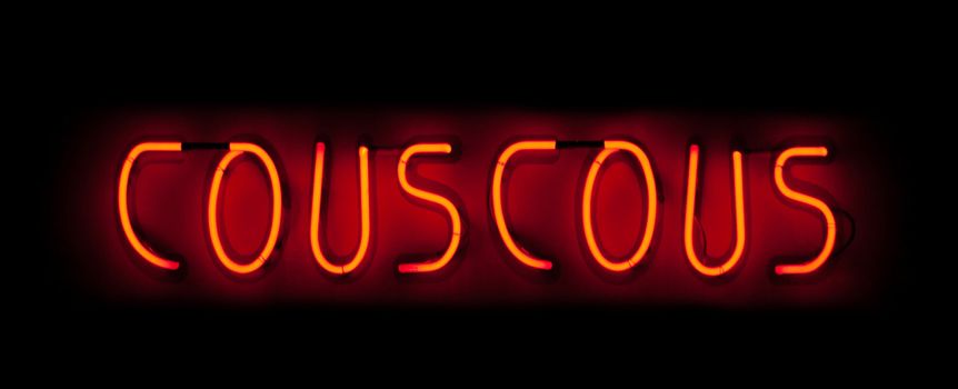 Couscous neon sign in red on black background in France