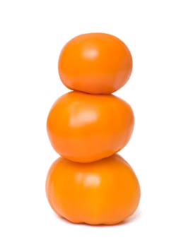 Orange tomatoes closeup isolated on white background.