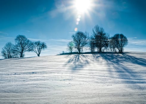 Sun over snowy Hill taken in Austria