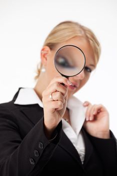 business woman looking through a magnifier