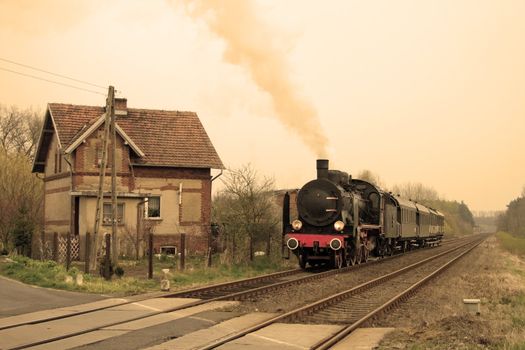 Vintage steam train passing through countryside
