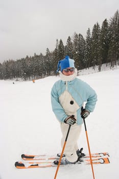 Female skier waiting on the slope